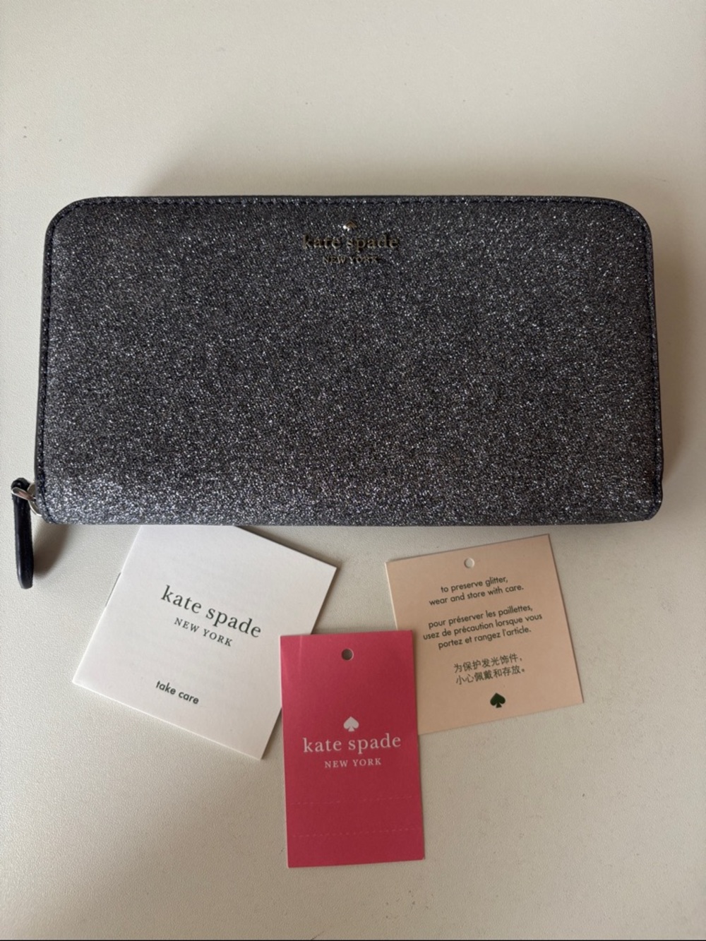 kate spade glitter zip-around wallet in dark silver sparkle